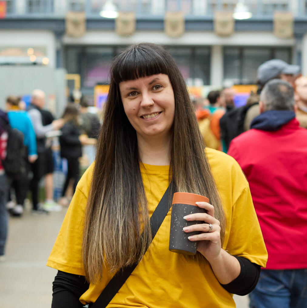 Gillian McIntyre holding a reusable coffee cup at Glasgow Coffee Festival